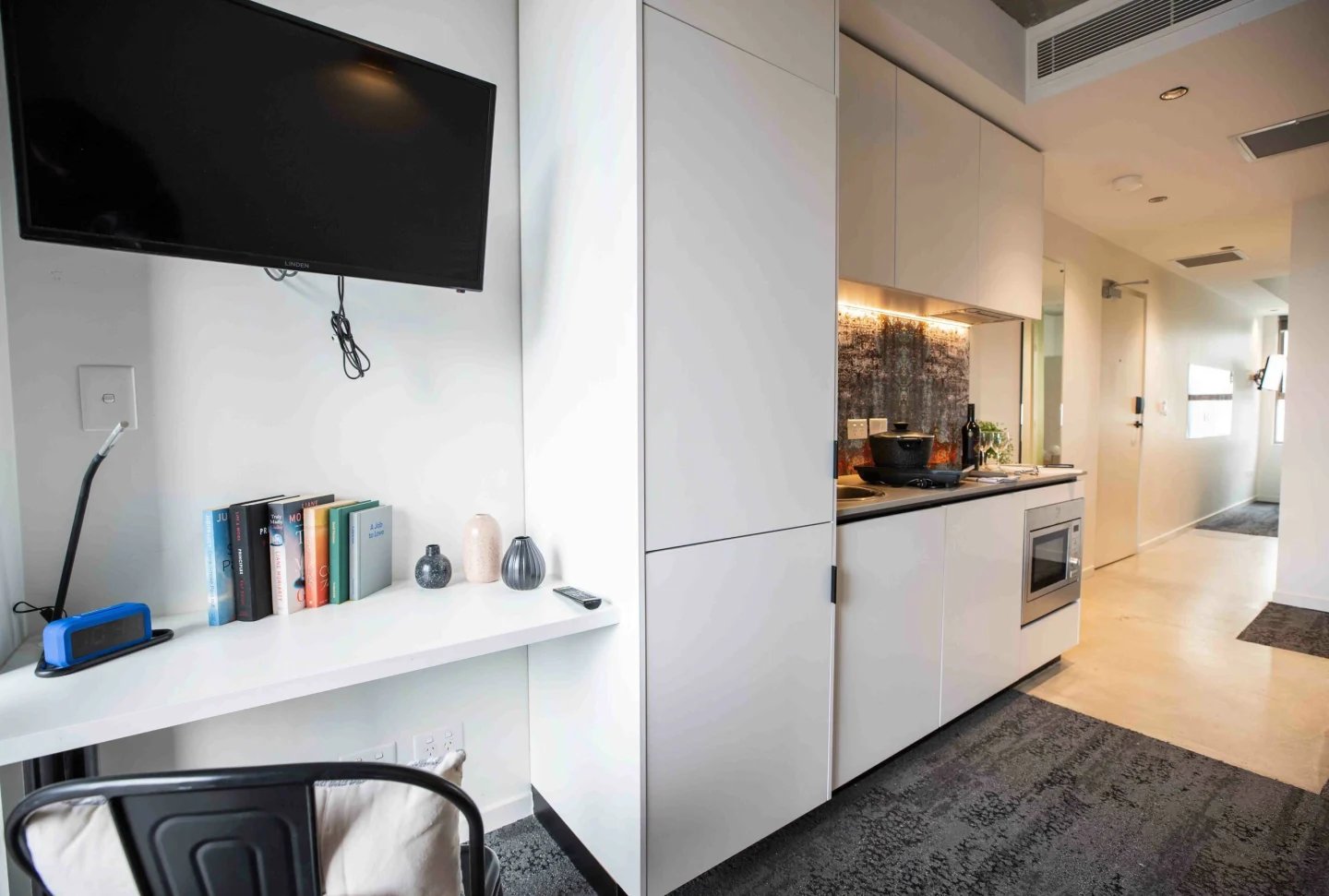 Television desk books vases microwave kitchen area at UKO Surry Hills in Sydney Student Accommodation