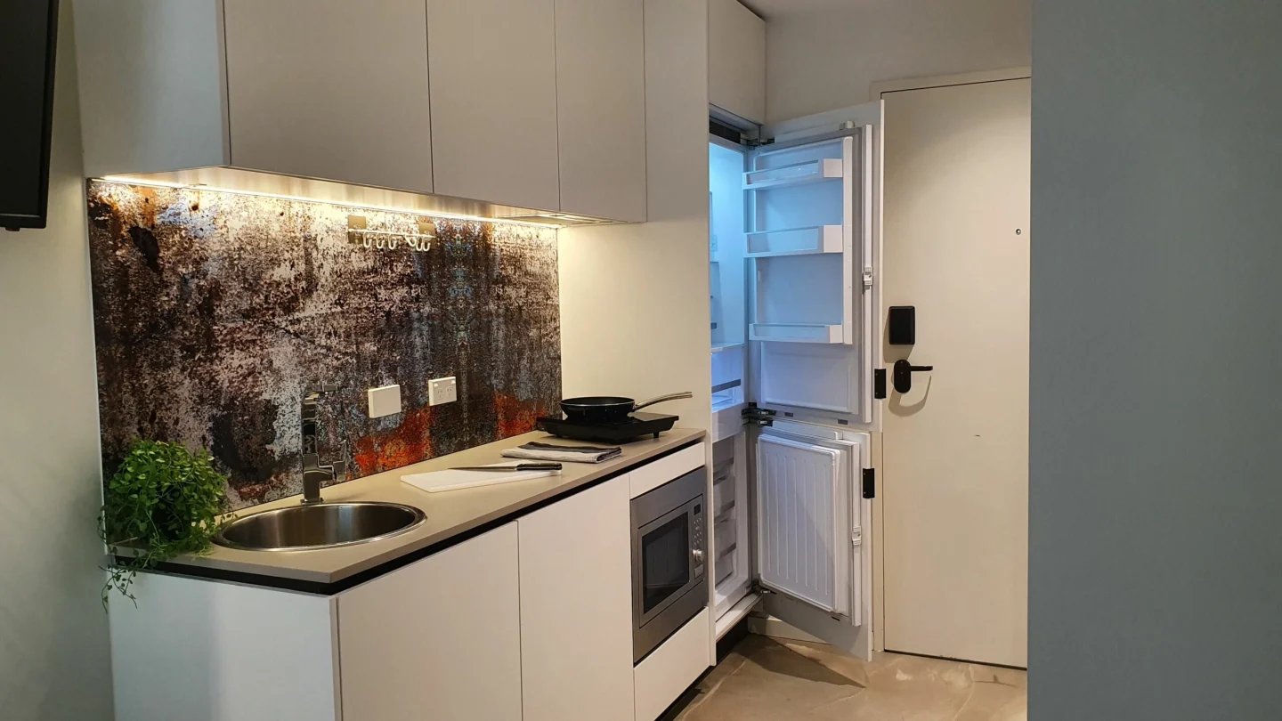 Small kitchen with fridge microwave and sink kitchen at UKO Surry Hills in Sydney Student Accommodation