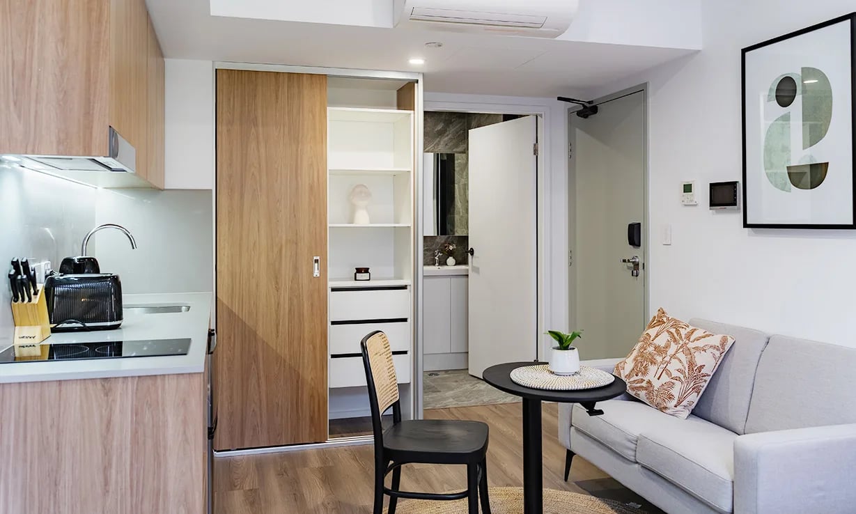 Kitchen couch and closet living room at UKO Sutherland in Sydney Student Accommodation