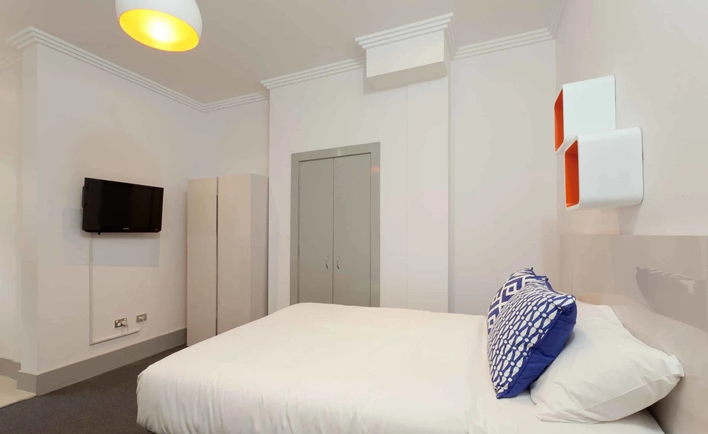 Bed TV wardrobe and shelves bedroom at ume Darlinghurst in Sydney Student Accommodation