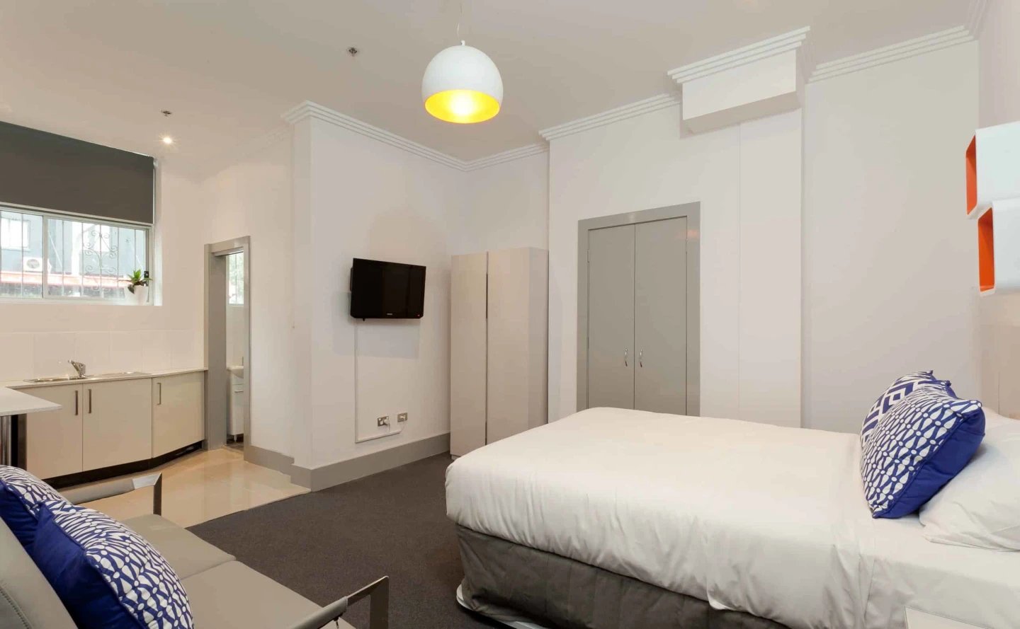Bed sofa kitchen cabinets television wardrobe bedroom at ume Darlinghurst in Sydney Student Accommodation