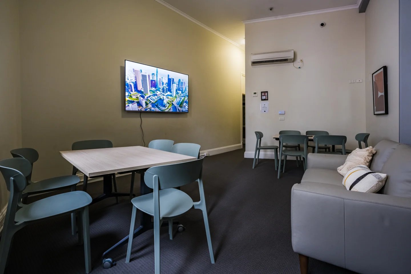 Table chairs television sofa living room at ume Haymarket in Sydney Student Accommodation