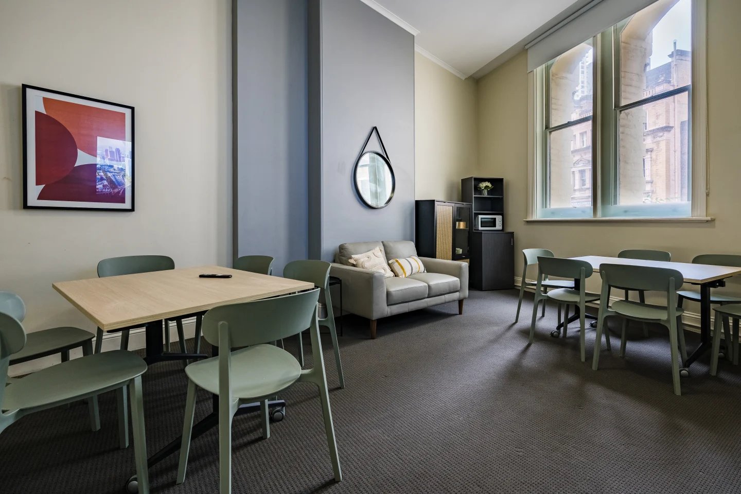 Tables chairs sofa artwork microwave living room at ume Haymarket in Sydney Student Accommodation