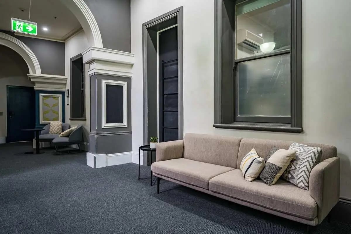 Sofa with pillows and table common area at ume Haymarket in Sydney Student Accommodation