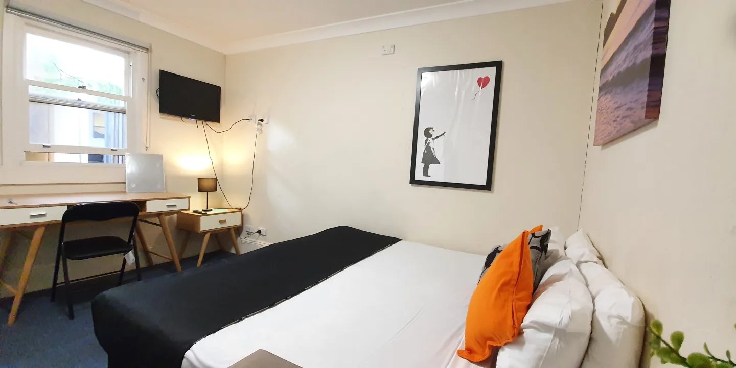 Desk television bed with pillows and art bedroom at ume Redfern in Sydney Student Accommodation