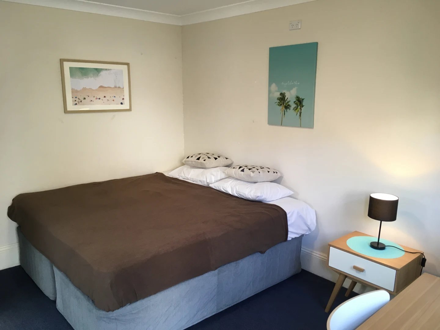 Bed with pillows artwork and nightstand Bedroom at ume Redfern in Sydney Student Accommodation