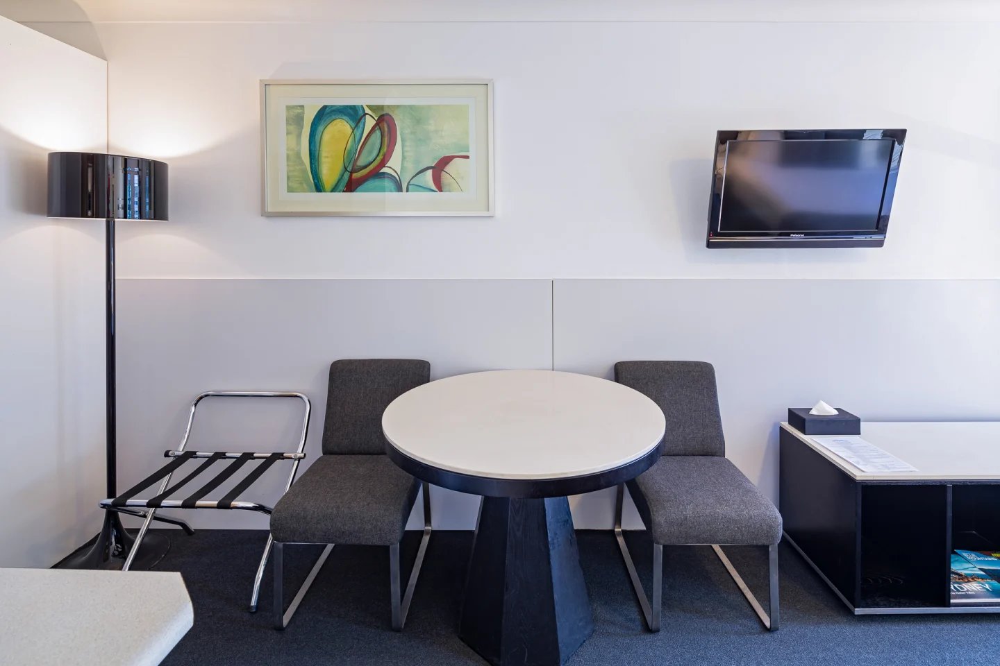 Artwork TV luggage rack table two chairs living room at ume Redfern Village in Sydney Student Accommodation