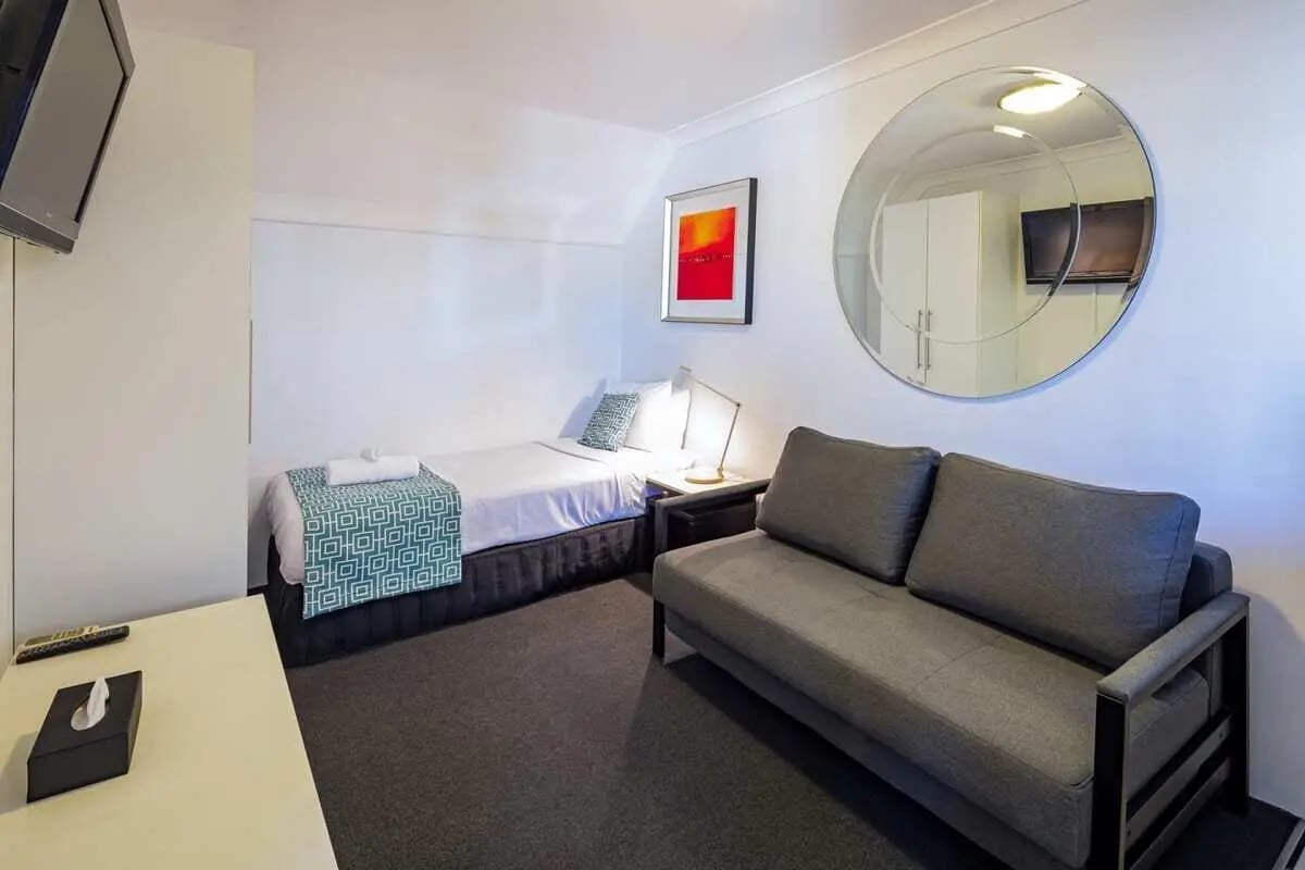 Bed sofa lamp mirror painting bedroom living area at ume Redfern Village in Sydney Student Accommodation