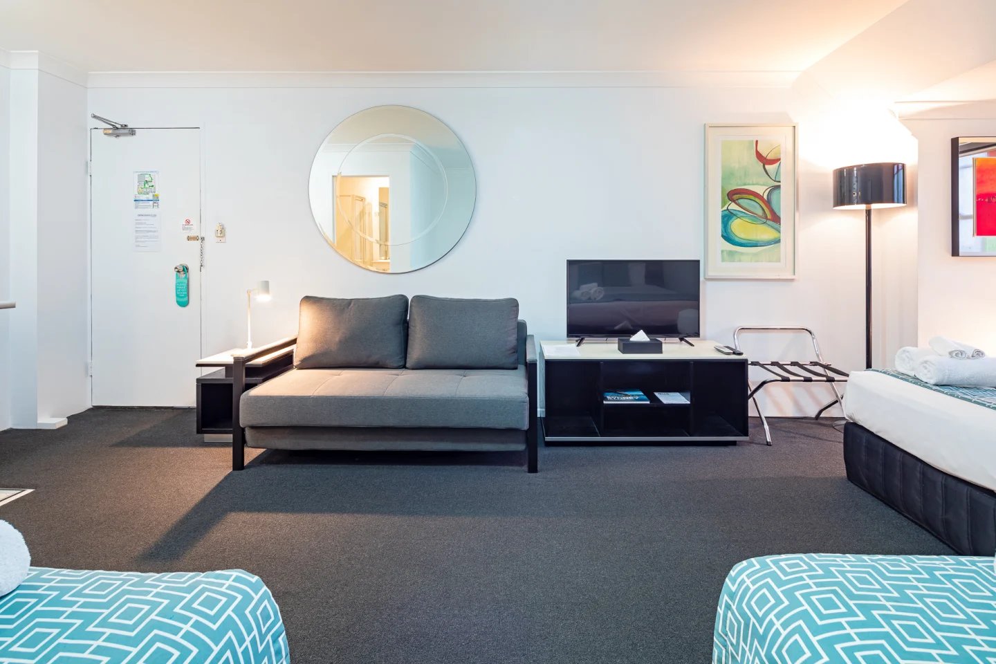 Sofa TV mirror artwork luggage rack living area at ume Redfern Village in Sydney Student Accommodation
