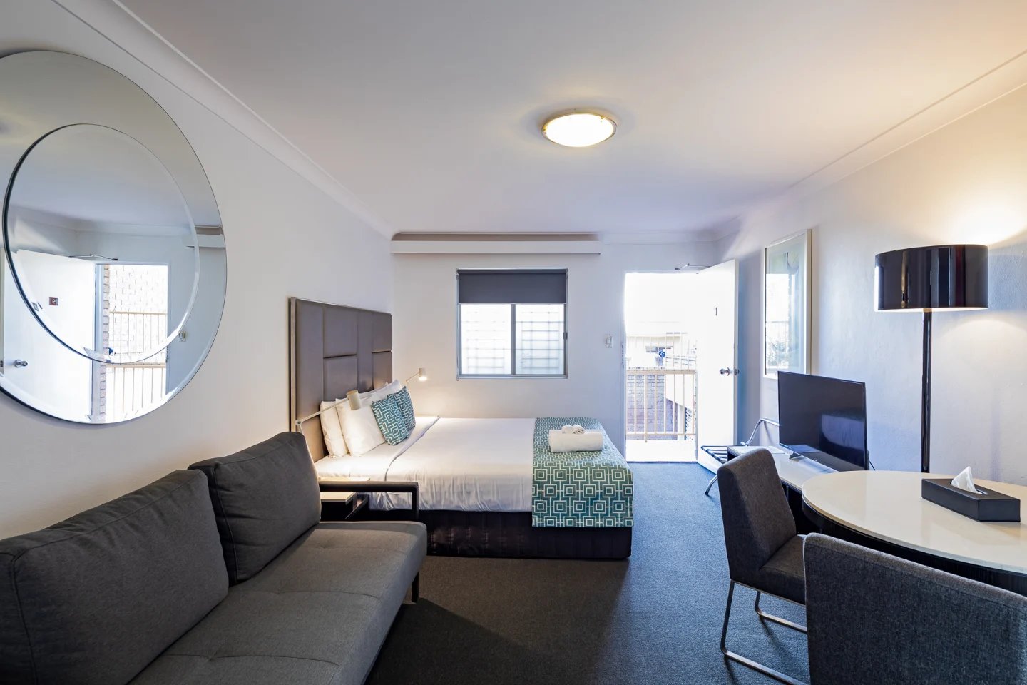 Bed sofa mirror TV dining table bedroom at ume Redfern Village in Sydney Student Accommodation