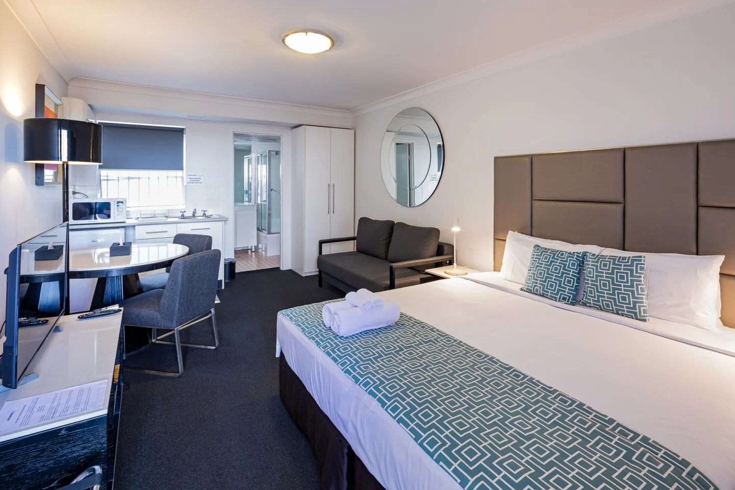 Studio apartment with bed sofa and kitchen area bedroom at ume Redfern Village in Sydney Student Accommodation