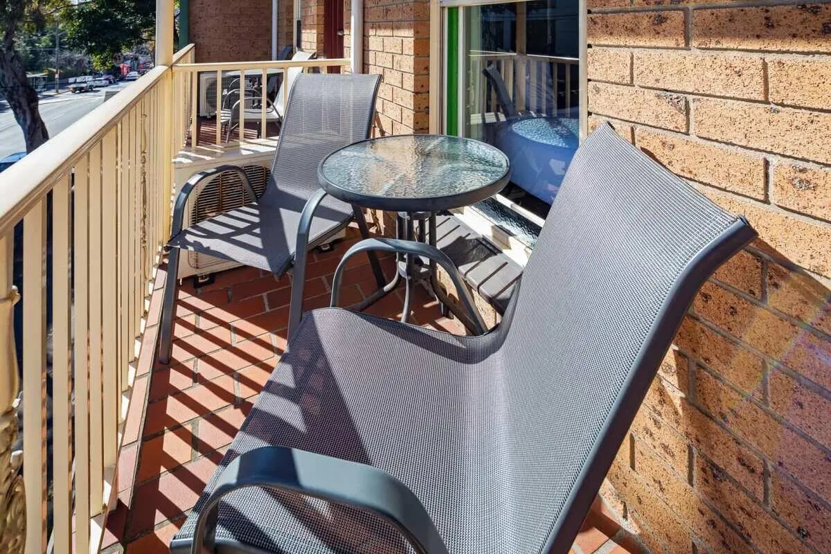 Two chairs and a table on balcony exterior at ume Redfern Village in Sydney Student Accommodation