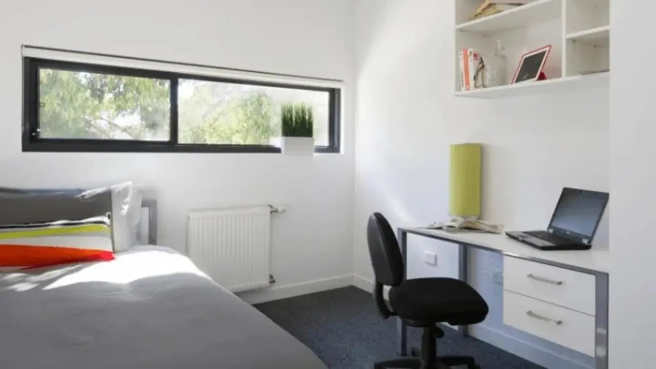 Bed desk laptop and chair bedroom at Western Sydney University Campbelltown Village in Sydney Student Accommodation