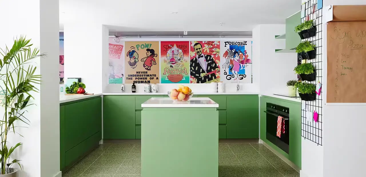 Green cabinets island fruit bowl posters kitchen at Scape Abercrombie in Sydney Student Accommodation