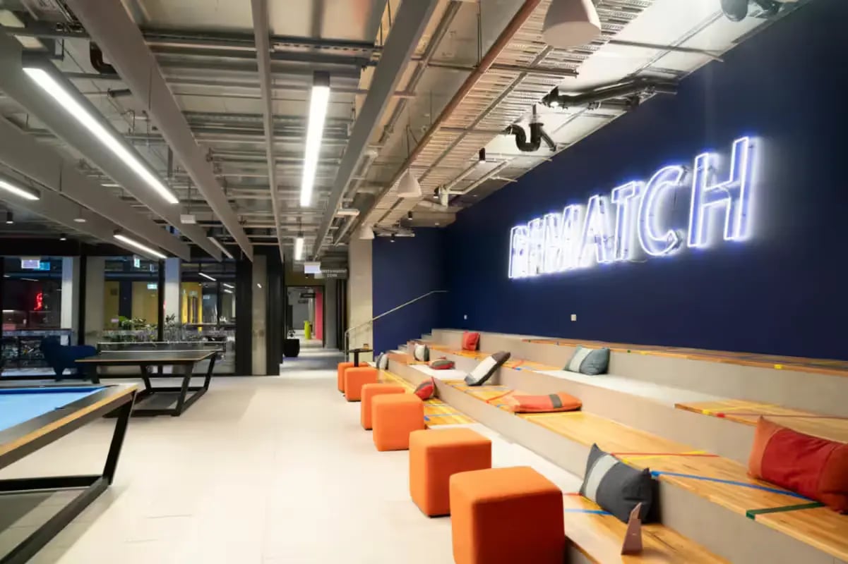 Seating area with neon sign and pool table communal space at Scape Cornell Place in Melbourne Student Accommodation