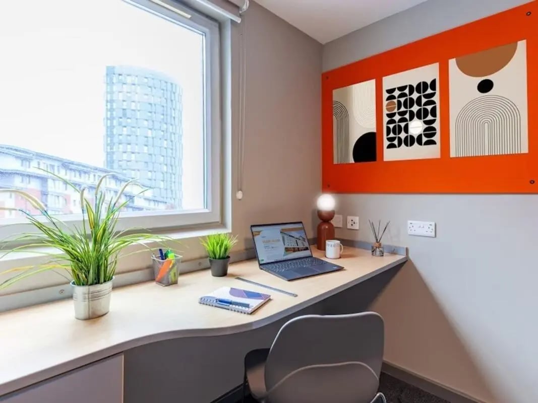 Desk with laptop and artwork study area at Filbert Village in Leicester Student Accommodation