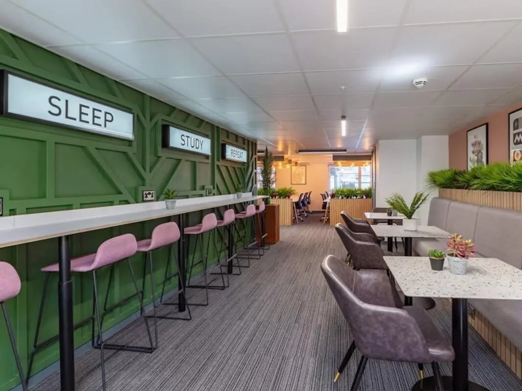 Bar seating and tables with chairs communal area at Filbert Village in Leicester Student Accommodation