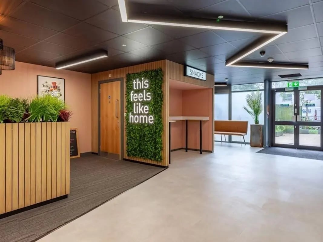 Interior lobby with plants snacks counter and seating area interior at Filbert Village in Leicester Student Accommodation