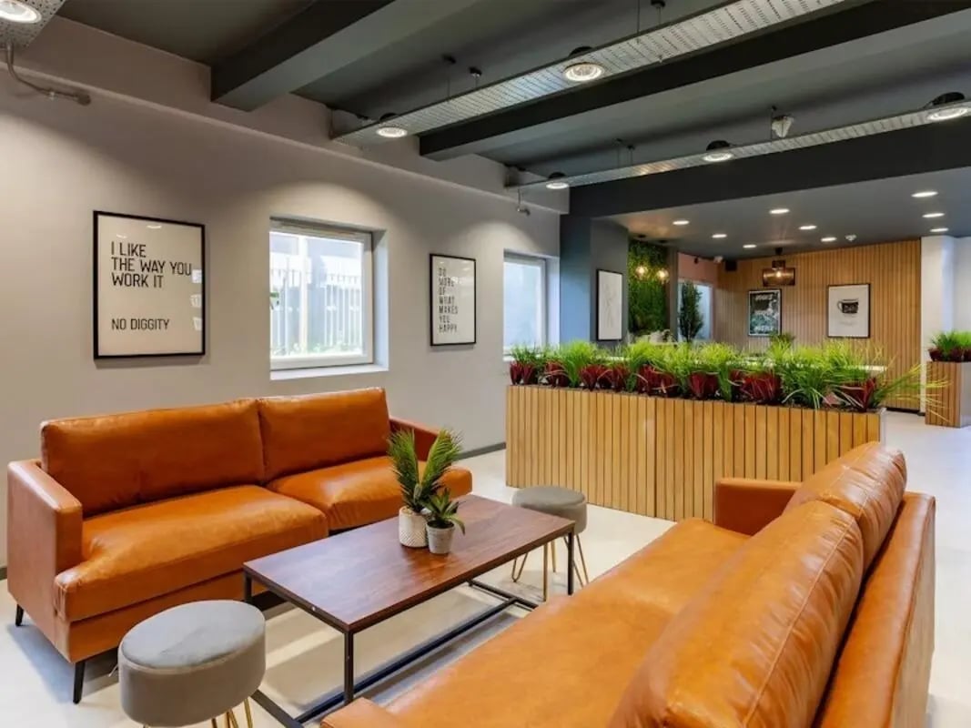 Orange sofas and coffee table living room at Filbert Village in Leicester Student Accommodation