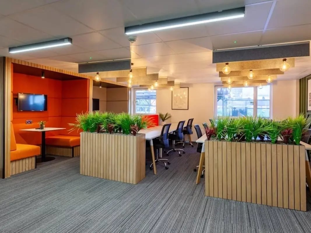 Orange booths TV desks chairs plants study area at Filbert Village in Leicester Student Accommodation