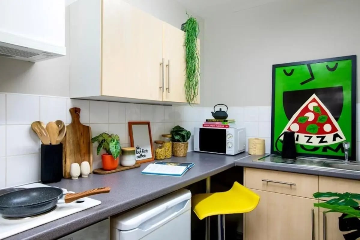 Countertop with microwave kettle and pizza art kitchen at Newarke Point in Leicester Student Accommodation