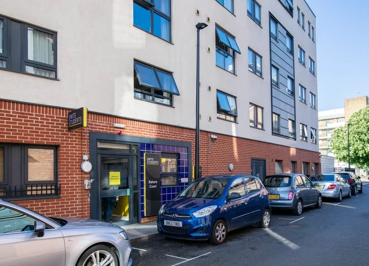 Student accommodation building entrance with parked cars exterior at Rahere Court in London Student Accommodation