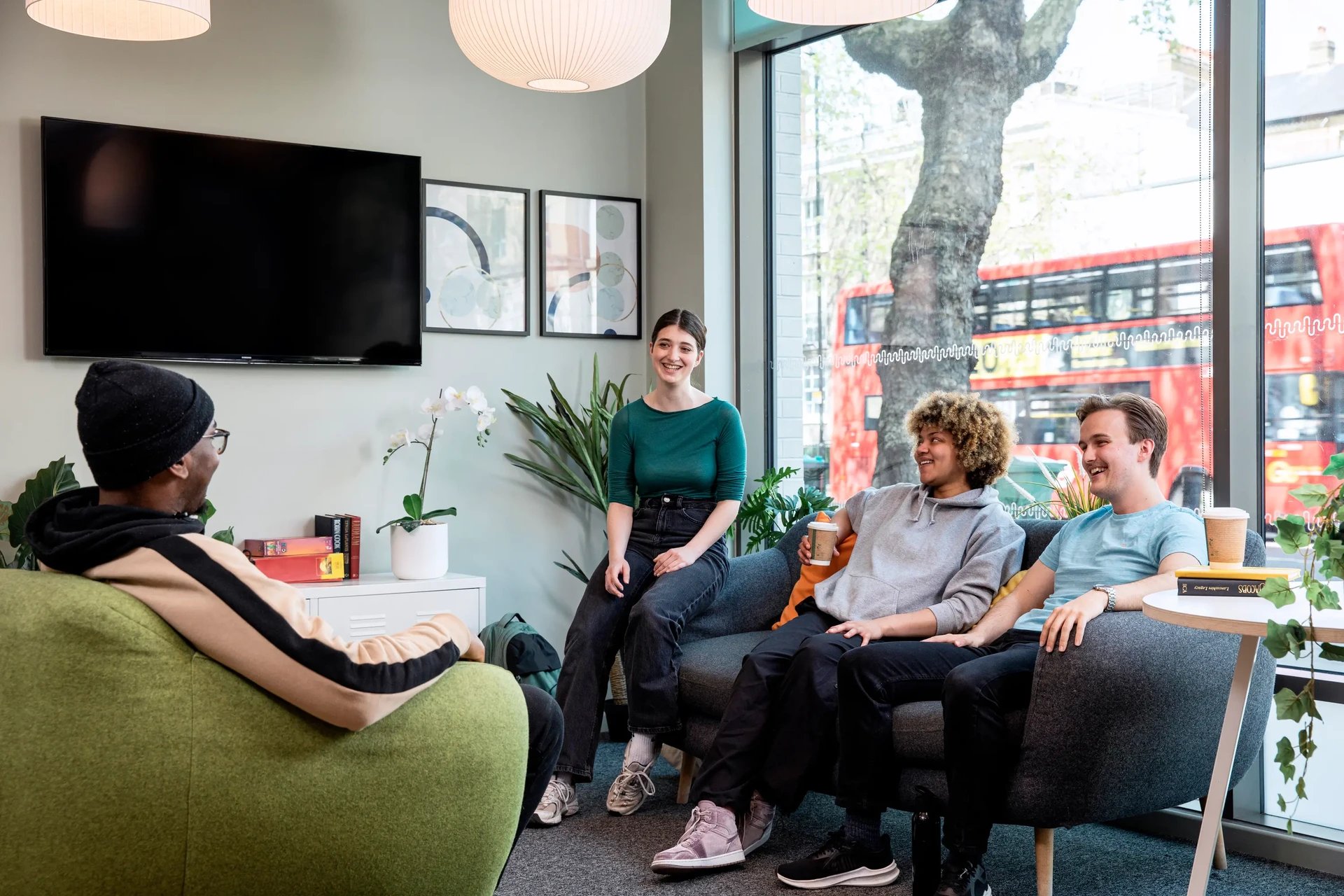 Students relaxing on sofas near window living room at Wellington Lodge in London Student Accommodation
