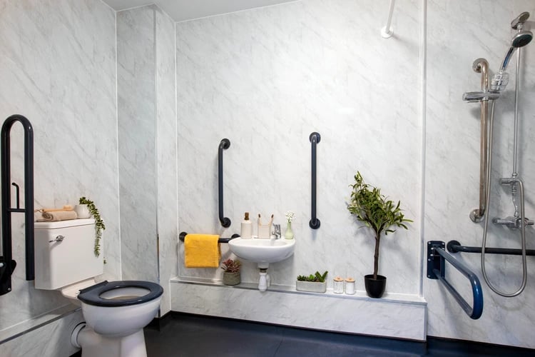 Toilet sink shower grab bars and plant bathroom at Piccadilly Court in London Student Accommodation