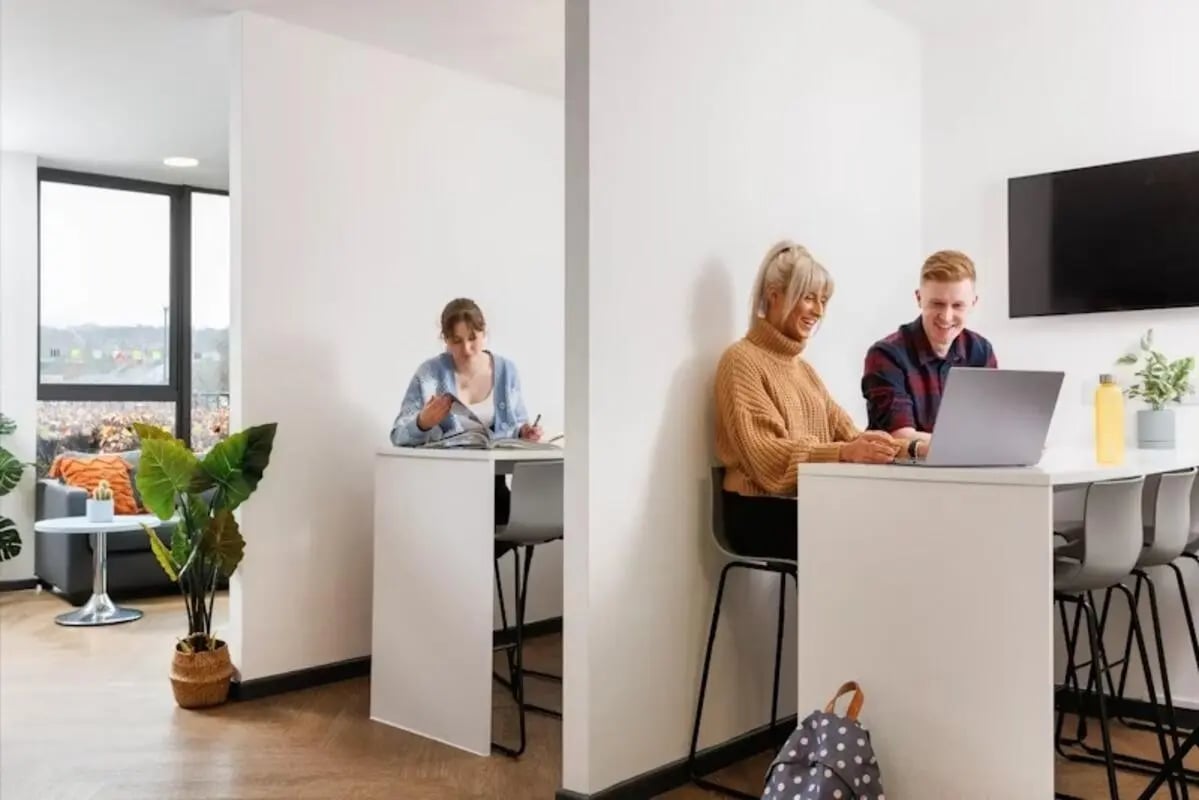 Students studying at desks and a laptop study area at The Anvil in Sheffield Student Accommodation