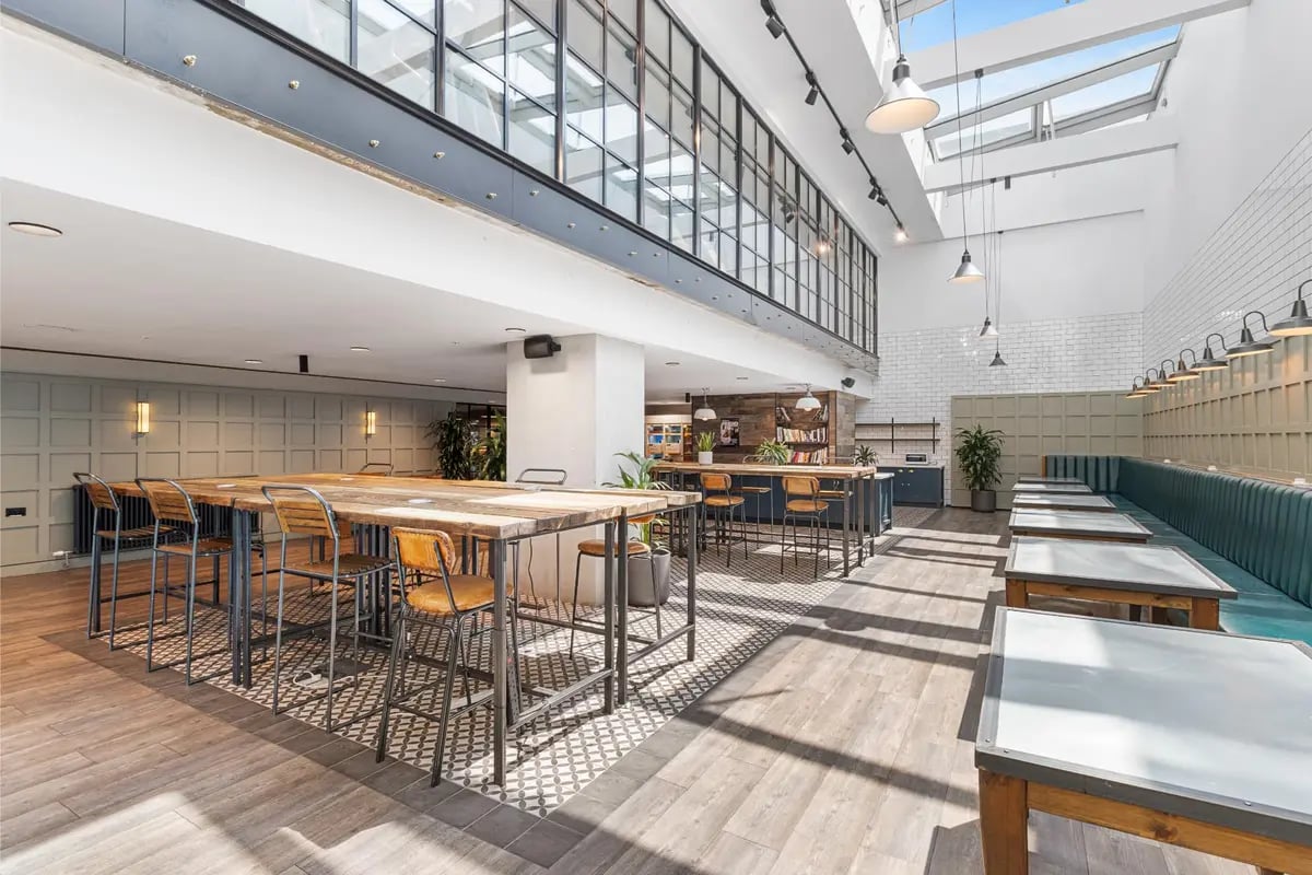 Communal tables benches and bar stools communal area at Chapter Kings Cross in London Student Accommodation