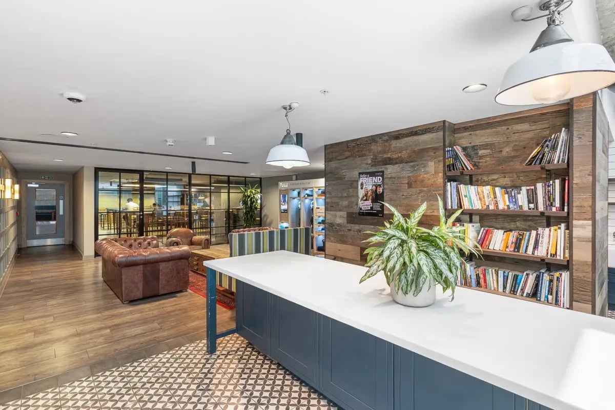 Lounge area with seating and bookshelves Living room at Chapter Kings Cross in London Student Accommodation