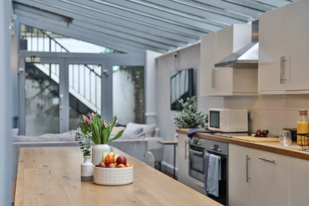 Table with fruit flowers stairs and kitchen Image Type Kitchen at Francis Gardner in London Student Accommodation