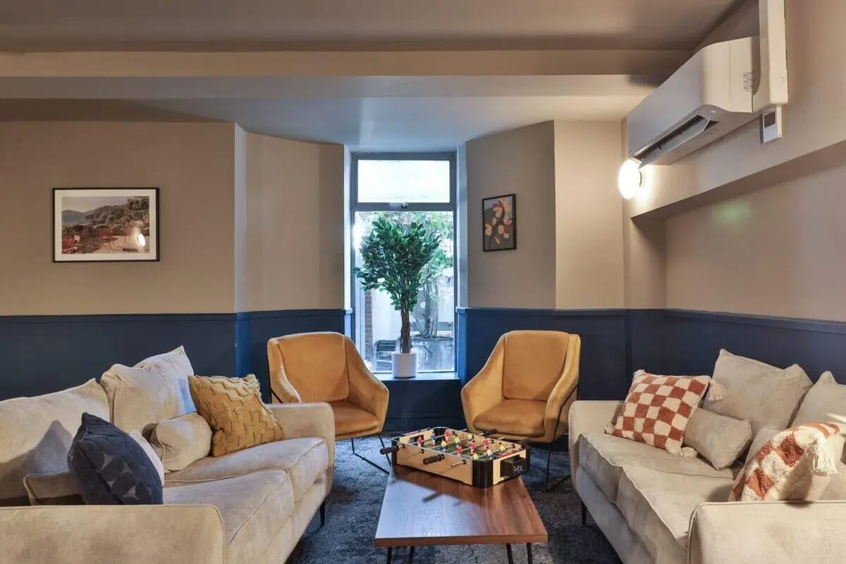 Sofas chairs foosball table living room at Francis Gardner in London Student Accommodation