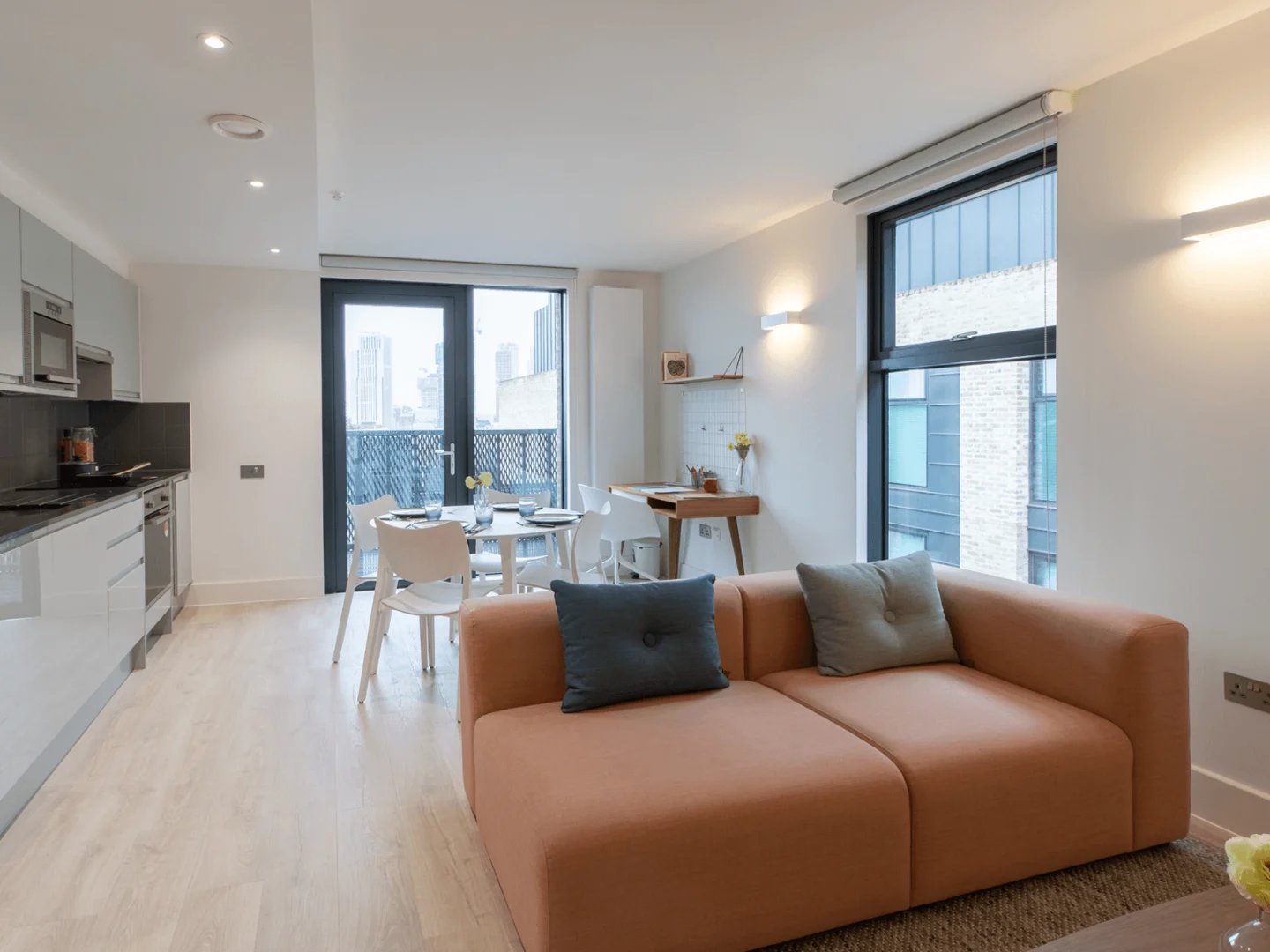 Sofa table chairs kitchen living room at Spring Mews in London Student Accommodation