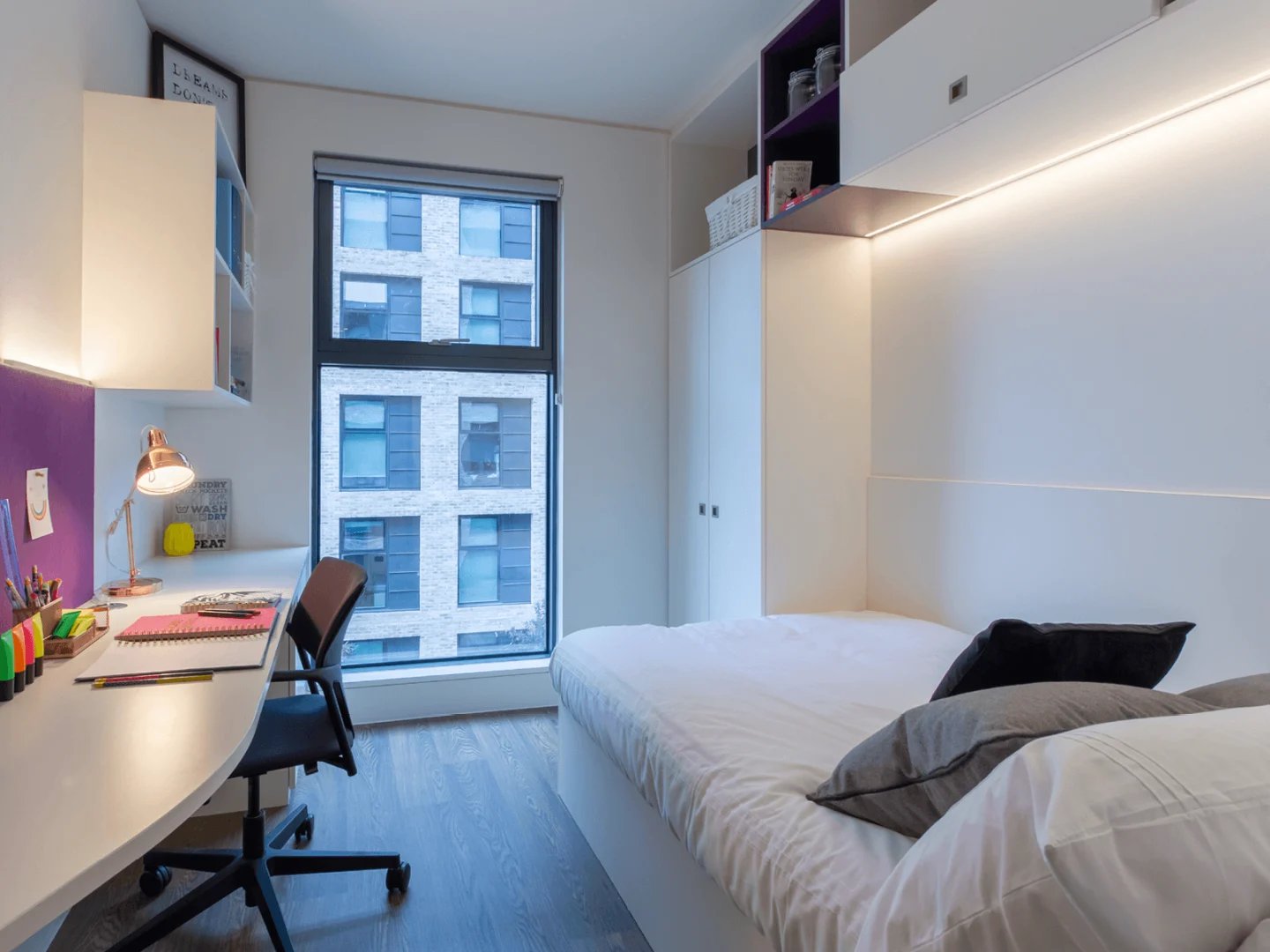 Desk chair lamp bed and window bedroom at Spring Mews in London Student Accommodation