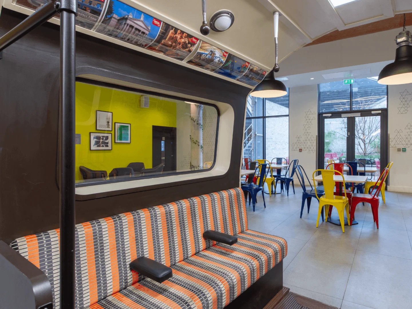 Colorful chairs tables patterned bench common area at Spring Mews in London Student Accommodation
