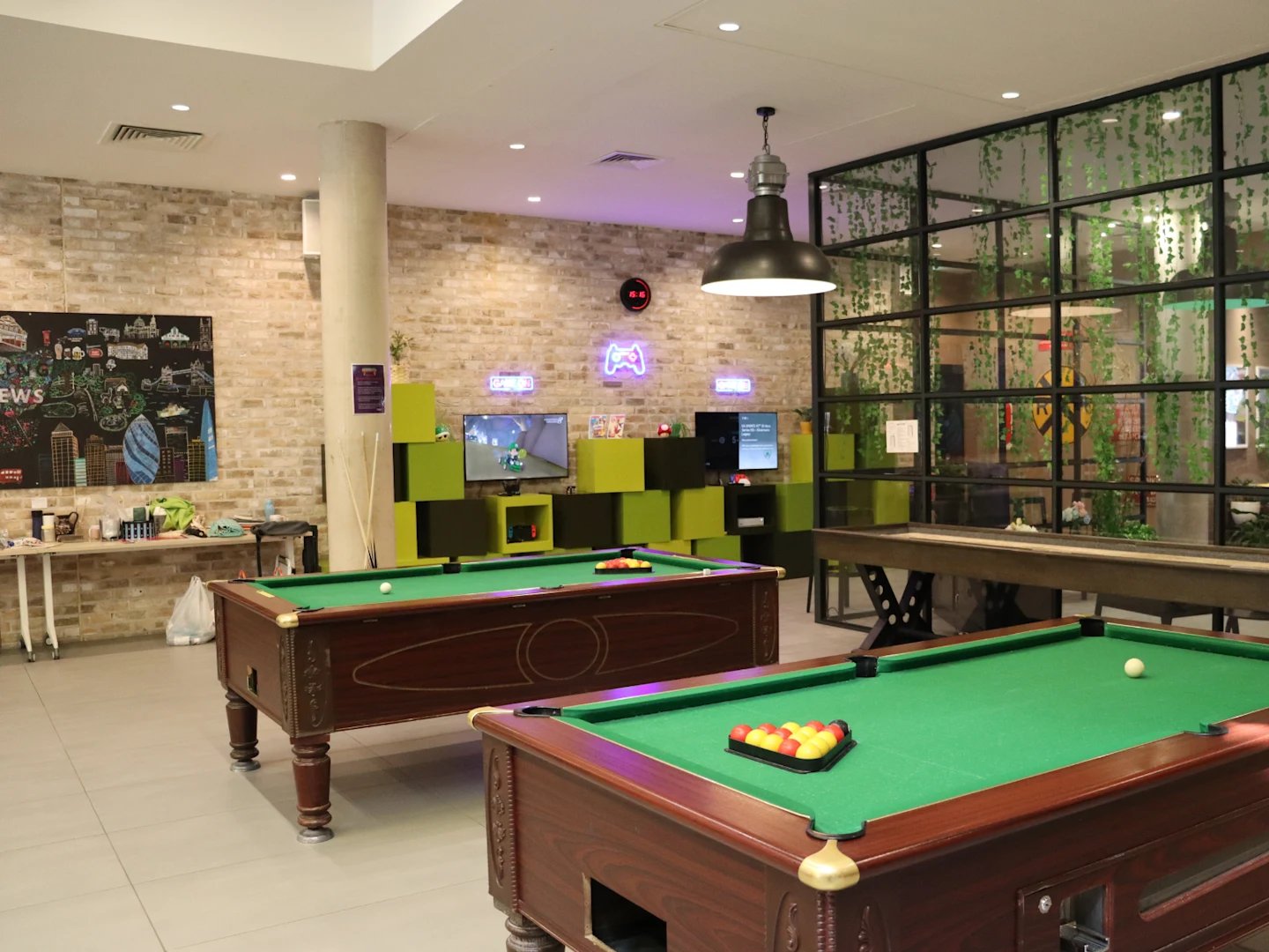 Pool tables and shuffleboard game area at Spring Mews in London Student Accommodation