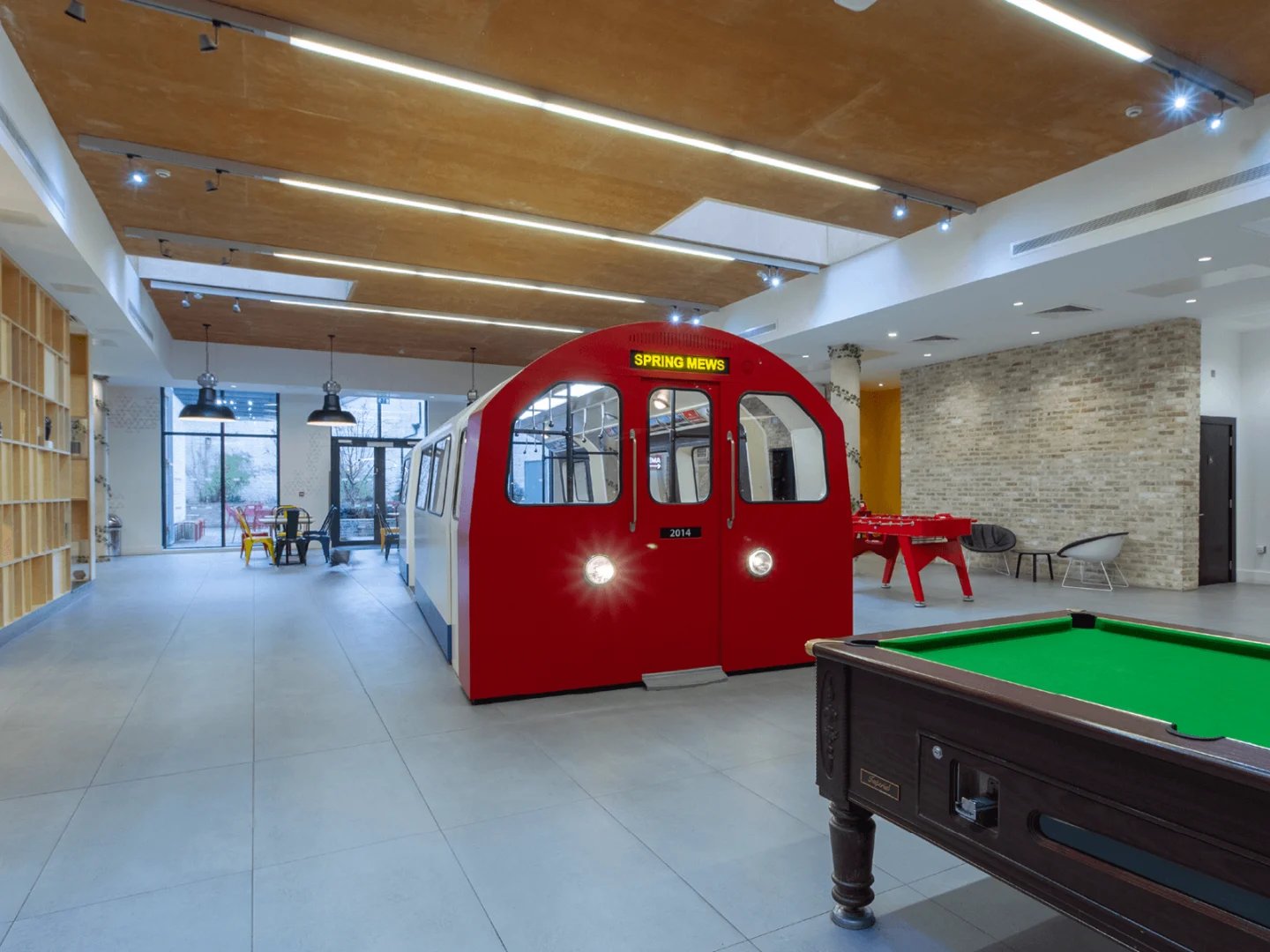 Red train carriage foosball and pool table common area at Spring Mews in London Student Accommodation