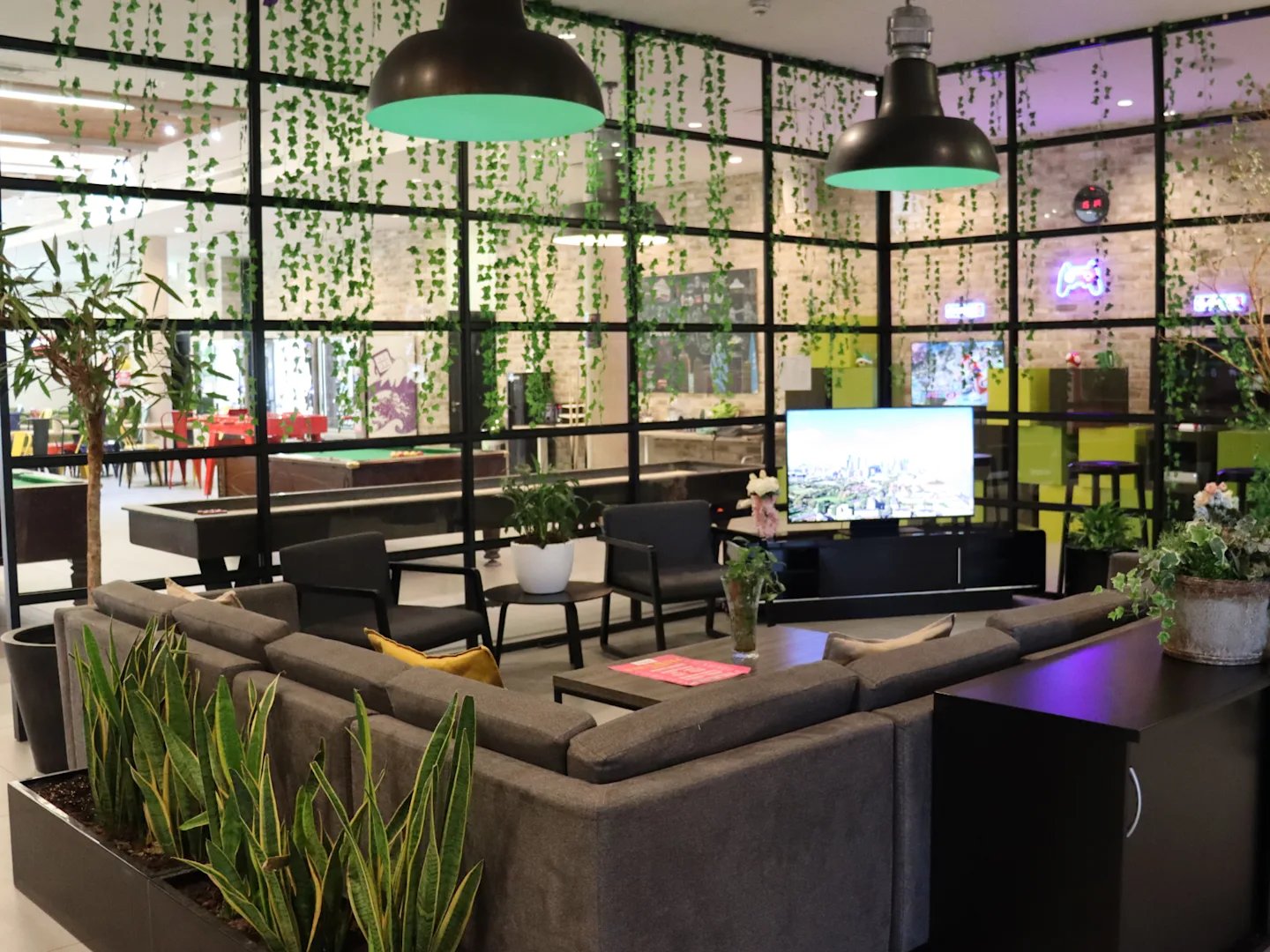 Sofa pool tables and TVs communal living room at Spring Mews in London Student Accommodation