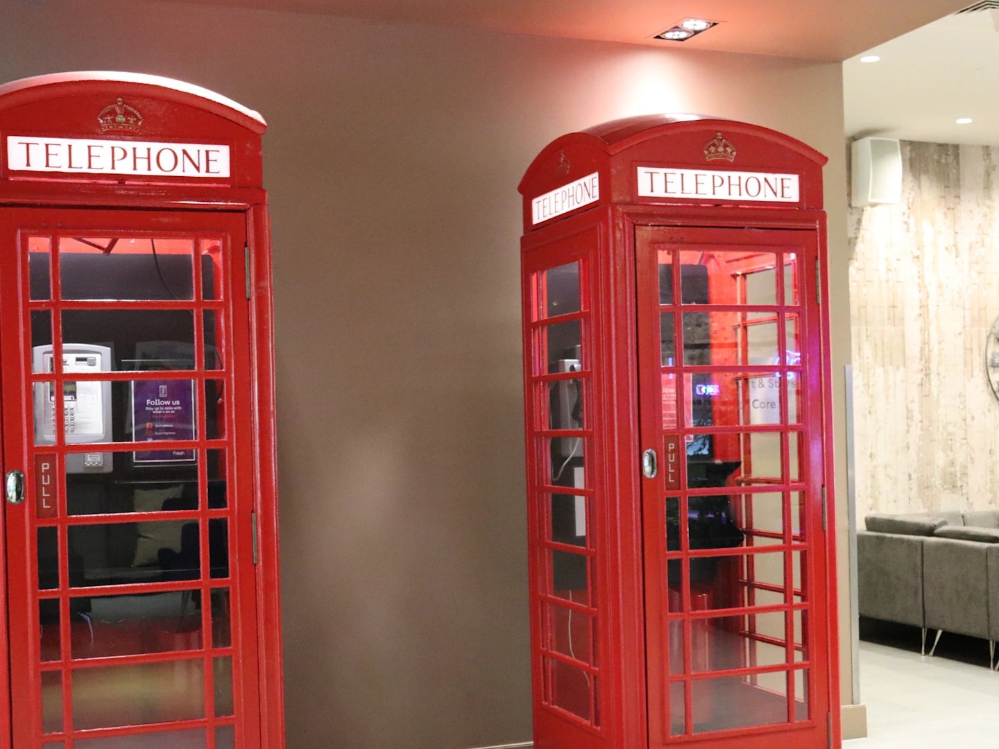 Red telephone booths with telephones and signs interior decoration at Spring Mews in London Student Accommodation
