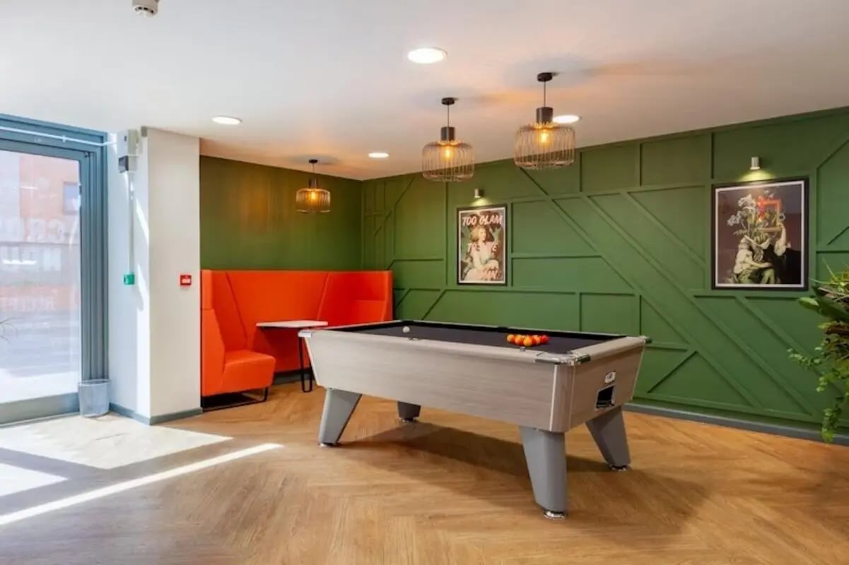 Pool table orange booths artwork living room at Crown House - Reading in Reading Student Accommodation