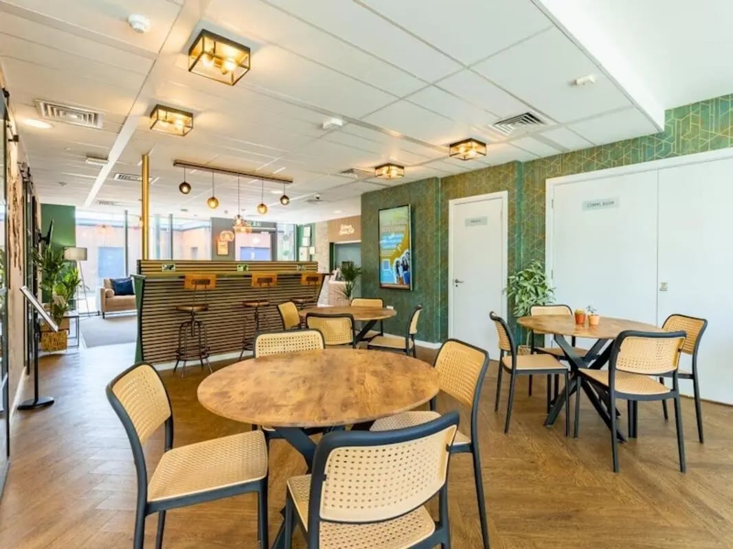 Wooden tables chairs bar area lounge living room at Kendrick Hall in Reading Student Accommodation