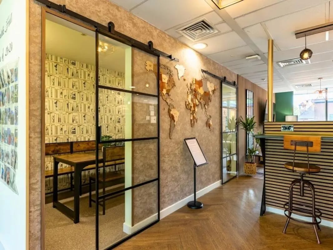 Table with benches and world map lounge at Kendrick Hall in Reading Student Accommodation