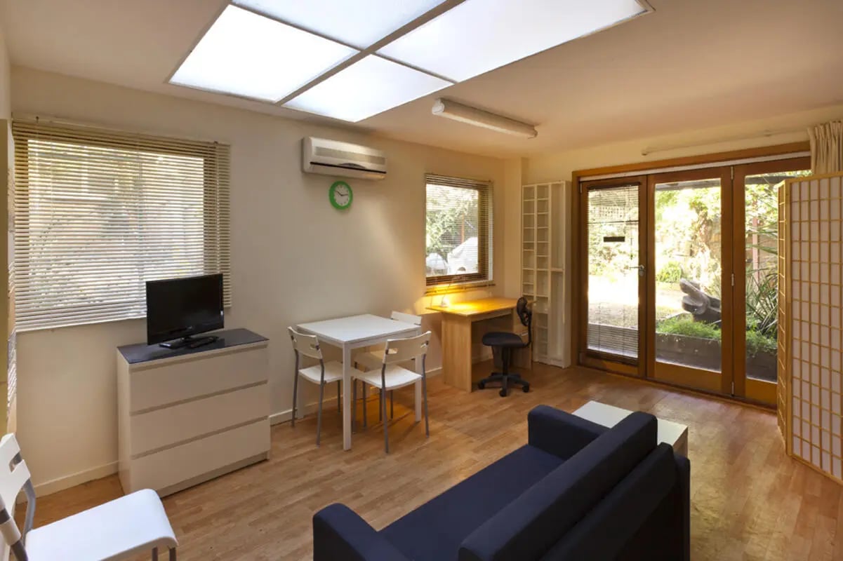 Sofa table desk and TV living room at Park Lane House in Melbourne Student Accommodation