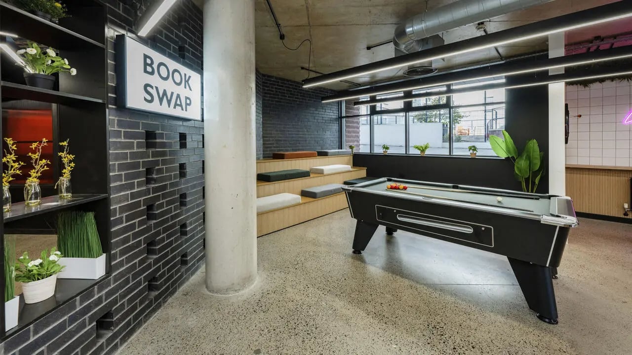 Pool table tiered seating book swap communal area at The Printworks in Exeter Student Accommodation