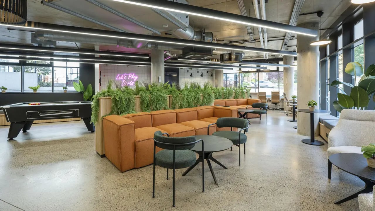 Pool table orange sofas green chairs lounge area at The Printworks in Exeter Student Accommodation