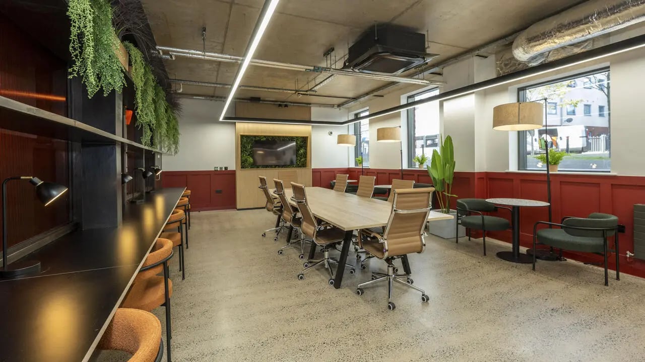 Large meeting table chairs plants and desks Common Area at The Printworks in Exeter Student Accommodation