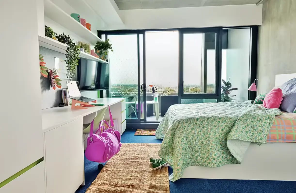 Bed desk and plants modern bedroom at Scape Victoria Street in Melbourne Student Accommodation