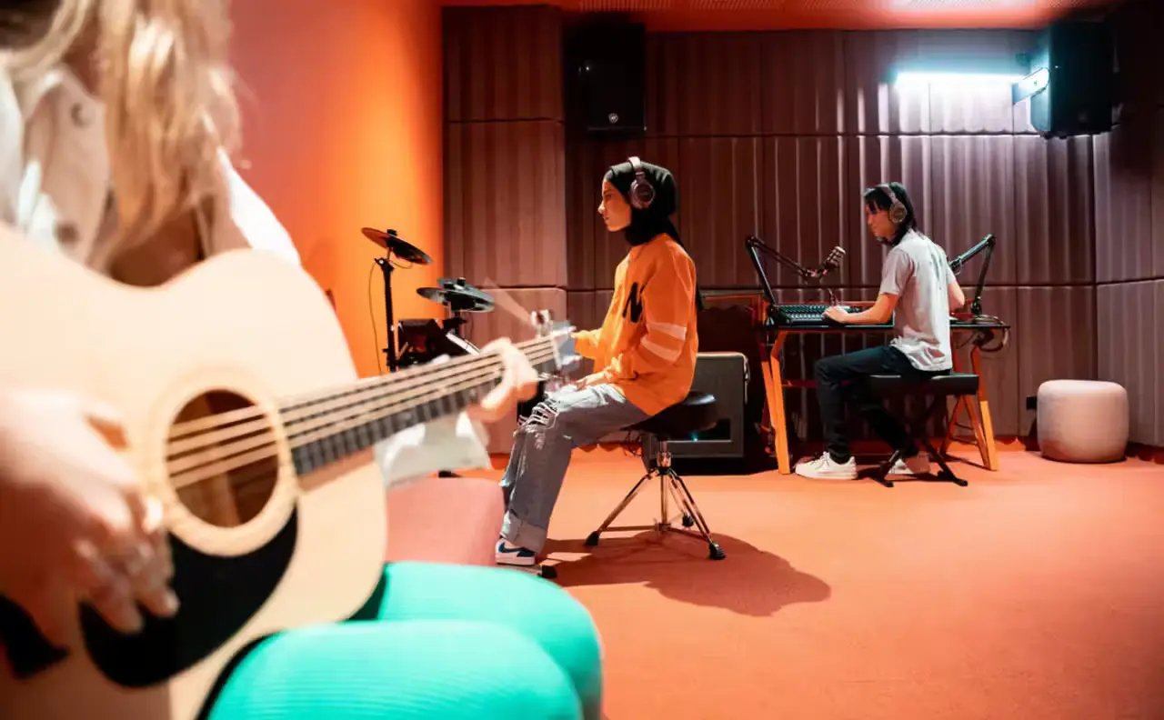 Musicians playing guitar drums keyboard sound studio at Scape Lincoln College in Melbourne Student Accommodation