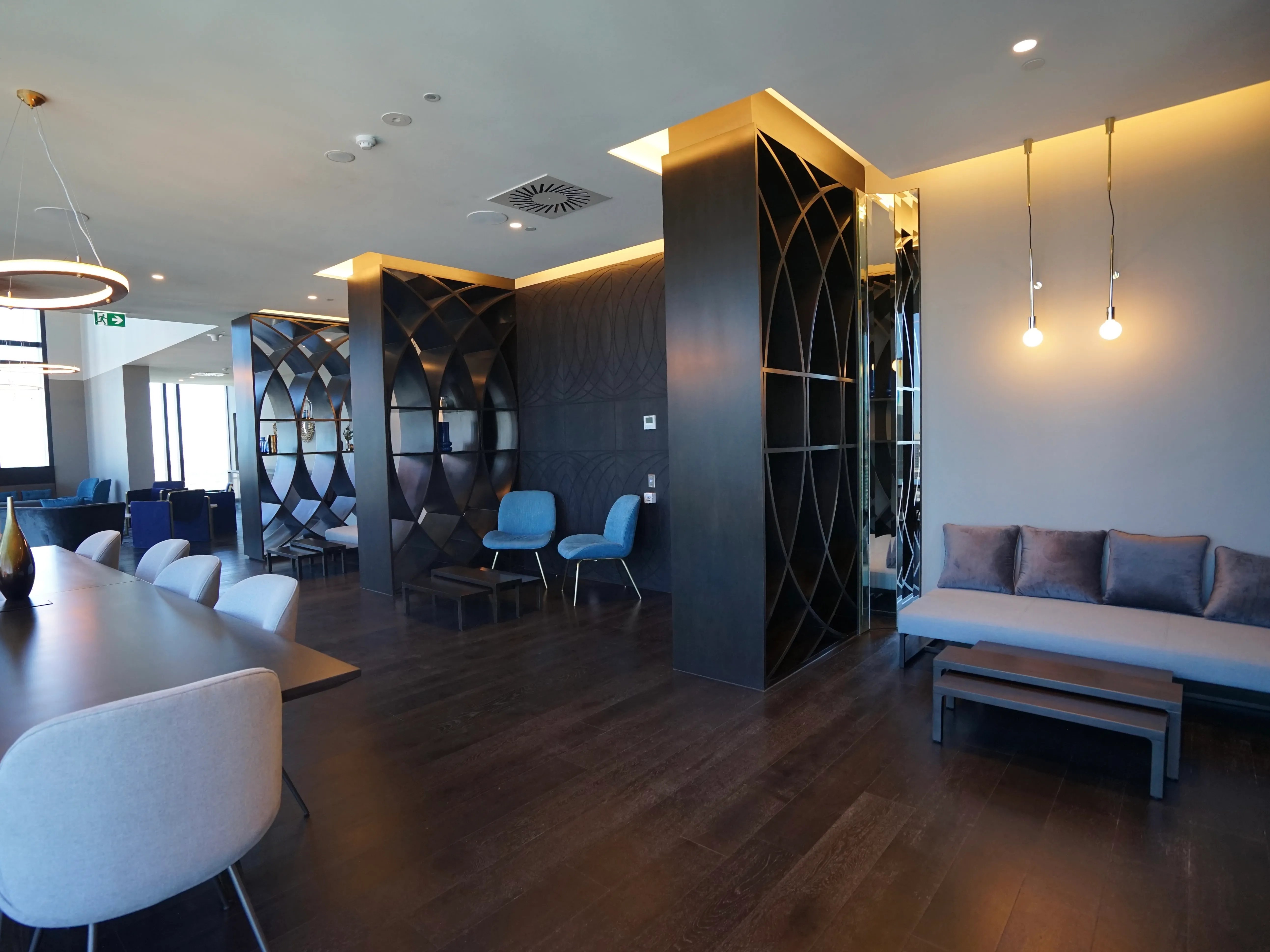 Modern lounge with seating dining table and shelves at Belong Melbourne CBD in Melbourne Student Accommodation